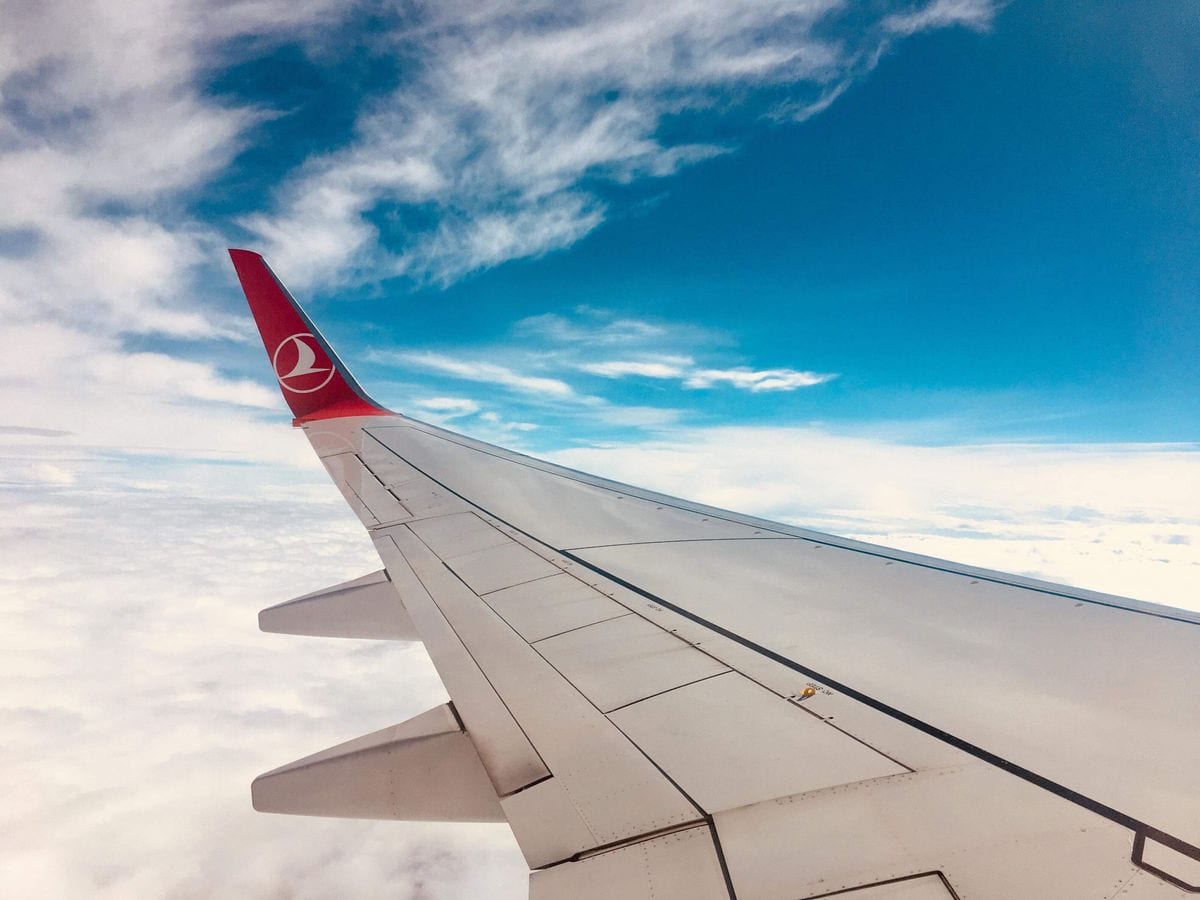 A polished winglet catching the light against the sky